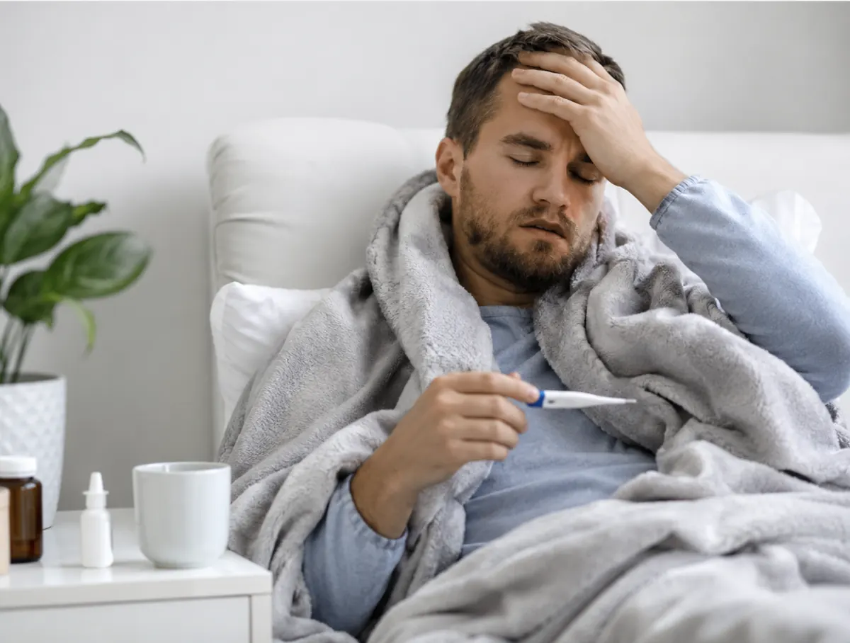 Hombre con fiebre descansando en casa